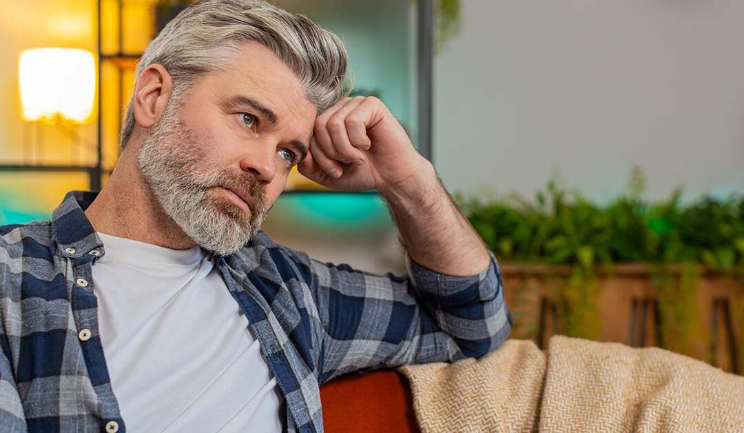 Man with graying hair on couch