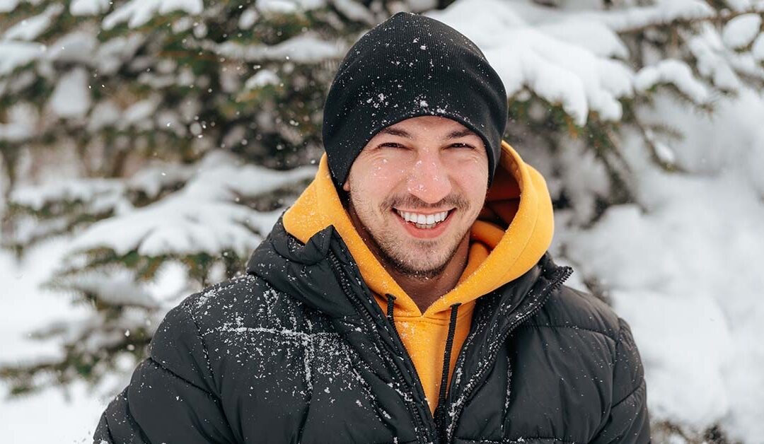 Man in winter clothes out in the snow.